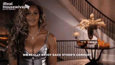 A Woman In A Silver Dress With The Words We Really Enjoy Each Other 'S Company Below Her GIF