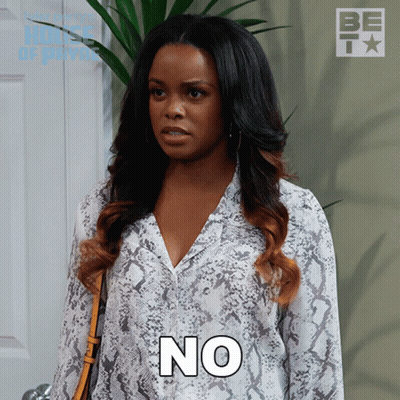 A Woman In A Snake Print Shirt Has The Word No On Her Chest GIF