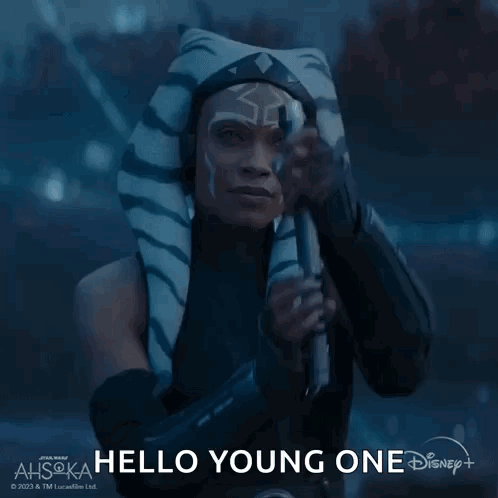 A Woman In A Star Wars Costume Is Holding A Light Saber And Saying Hello Young One GIF