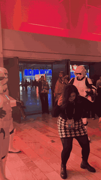 A Woman In A Storm Trooper Costume Is Dancing GIF