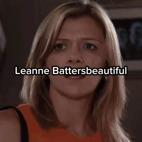 A Woman In A Strapless Dress Holds A Soap Award GIF
