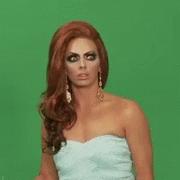 A Woman In A Strapless White Dress Is Making A Funny Face . GIF