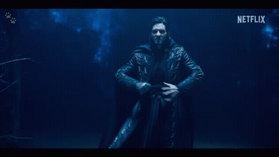 A Woman In A Striped Jacket With Netflix Written On The Bottom GIF
