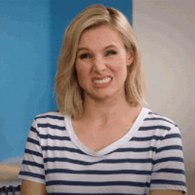 A Woman In A Striped Shirt Is Making A Funny Face . GIF
