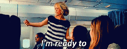 A Woman In A Striped Shirt Says I 'M Ready To On A Plane GIF