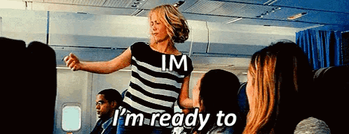 A Woman In A Striped Shirt Says I 'M Ready To On An Airplane GIF
