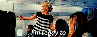 A Woman In A Striped Shirt Says I 'M Ready To On An Airplane GIF
