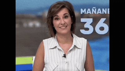 A Woman In A Striped Shirt Stands In Front Of A Sign That Says Mañana 36 GIF