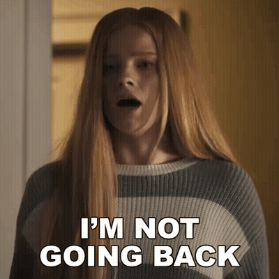 A Woman In A Striped Sweater Is Saying I 'M Not Going Back . GIF