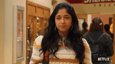 A Woman In A Striped Sweater Is Standing In Front Of A Chick-Fil-A Sign GIF