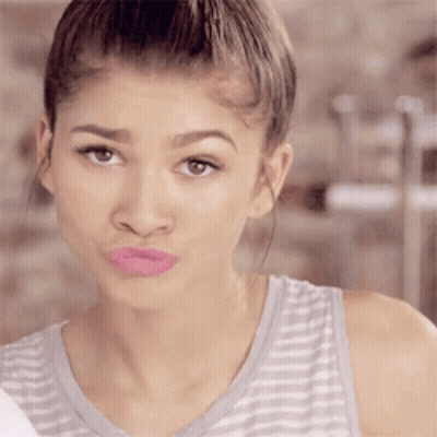 A Woman In A Striped Tank Top With Pink Lipstick On Her Lips GIF