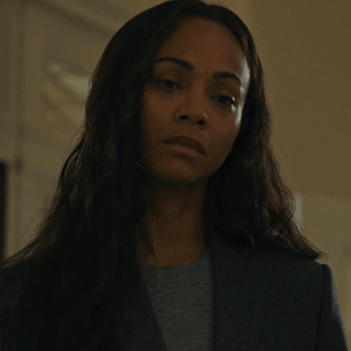 A Woman In A Suit And A Grey Shirt Says Yes GIF
