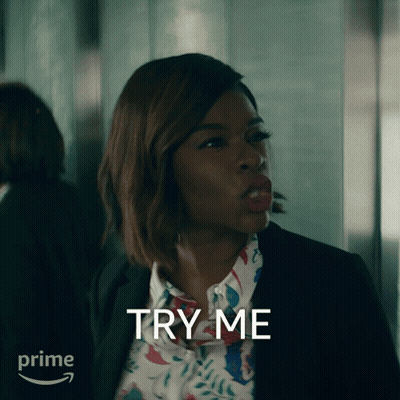 A Woman In A Suit And Floral Shirt Says Try Me In Front Of A Prime Logo GIF