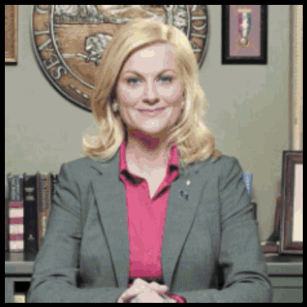A Woman In A Suit And Pink Shirt Is Smiling In Front Of A Seal That Says Sea GIF