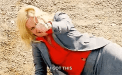 A Woman In A Suit And Red Sweater Is Laying On The Ground And Saying `` I Got This '' . GIF