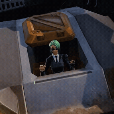A Woman In A Suit And Tie Is Standing In A Container GIF