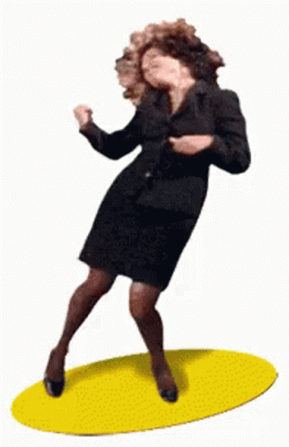A Woman In A Suit Is Dancing On A Yellow Rug GIF
