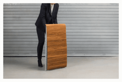 A Woman In A Suit Is Holding A Wooden Plank GIF