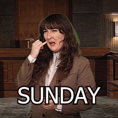 A Woman In A Suit Is Making A Funny Face In Front Of A Sign That Says " Sunday " GIF