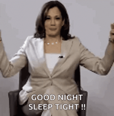 A Woman In A Suit Is Sitting In A Chair With Her Arms In The Air And Says `` Good Night Sleep Tight '' . GIF
