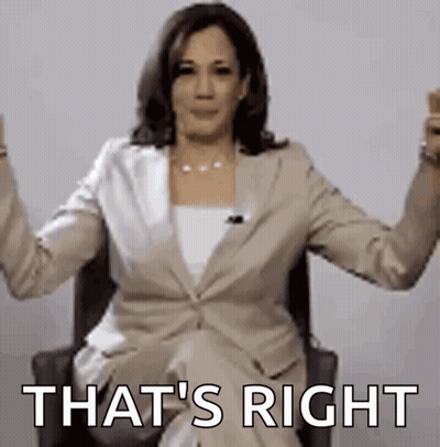 A Woman In A Suit Is Sitting In A Chair With Her Arms Outstretched And The Words `` That 'S Right '' . GIF