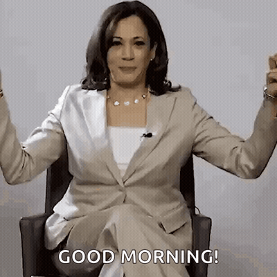 A Woman In A Suit Is Sitting In A Chair With Her Arms Outstretched . GIF