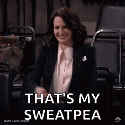 A Woman In A Suit Is Sitting In A Chair With The Words That 'S My Sweatpea GIF