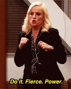 A Woman In A Suit Is Standing In Front Of A Window And Says `` Do It . Fierce . Power . '' GIF