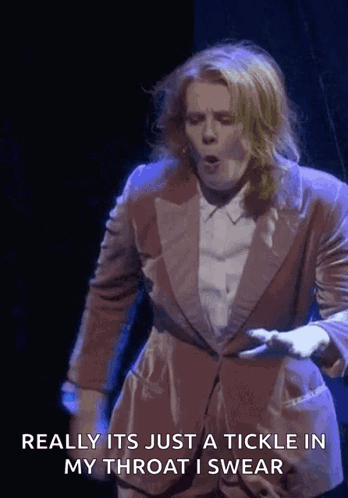 A Woman In A Suit Says Really It 'S Just A Tickle In My Throat GIF