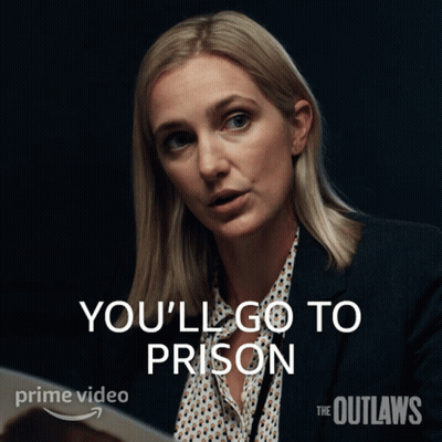 A Woman In A Suit Says " You 'Ll Go To Prison " In White Letters GIF