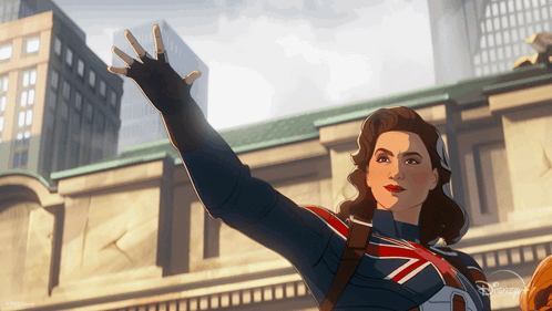 A Woman In A Superhero Costume Is Waving Her Hand In Front Of A Building GIF
