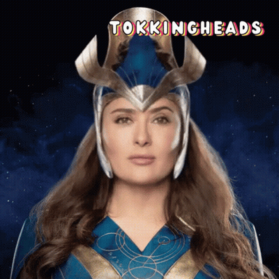 A Woman In A Superhero Costume With The Words Talkingheads On The Bottom GIF