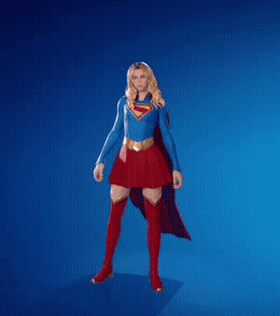 A Woman In A Superman Costume Is Dancing With Her Fist In The Air GIF