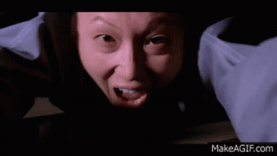 A Woman In A Surgical Gown Is Crawling On A Table GIF