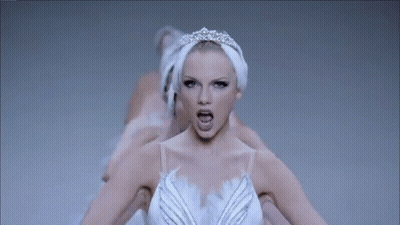 A Woman In A Swan Dress Is Surrounded By Other Swans . GIF