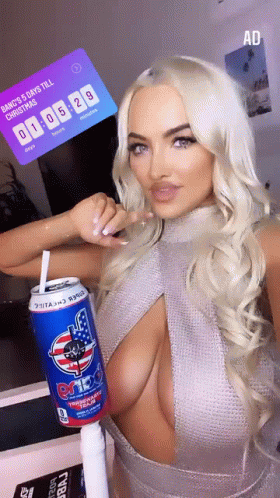 A Woman In A Sweater Is Holding A Can Of Energy Drink With A Straw In Her Hand . GIF
