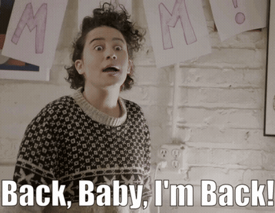 A Woman In A Sweater With The Words Back Baby I 'M Back GIF