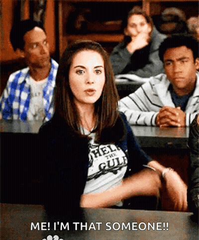 A Woman In A T-Shirt That Says Hell On The Gulf Is Sitting In A Classroom With Other People GIF