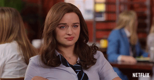A Woman In A Tie Sits At A Table With Netflix Written On The Bottom GIF