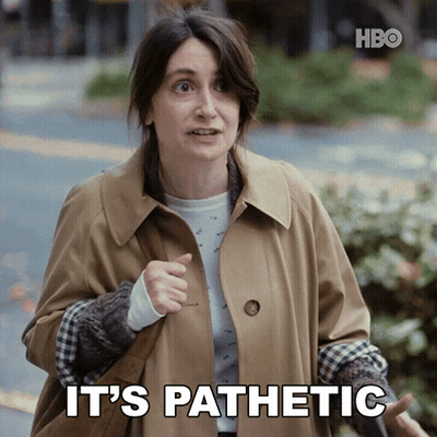 A Woman In A Trench Coat Says It 'S Pathetic While Pointing GIF