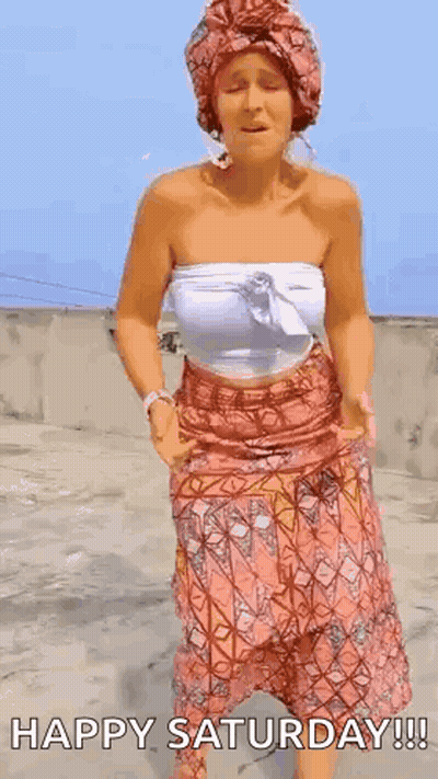 A Woman In A Turban Is Dancing On A Rooftop . GIF
