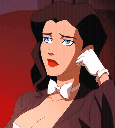 A Woman In A Tuxedo And Bow Tie Is Holding Her Hand To Her Face GIF