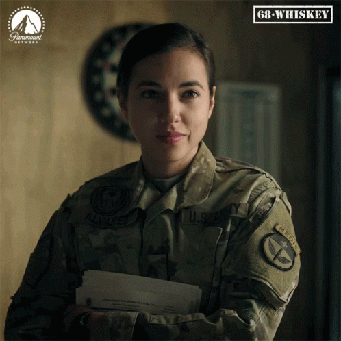 A Woman In A U.s. Army Uniform Is Holding A Letter GIF