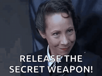 A Woman In A Uniform Is Smiling And Says `` Release The Secret Weapon ! '' GIF