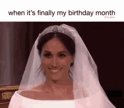 A Woman In A Wedding Dress And Tiara Is Smiling . GIF