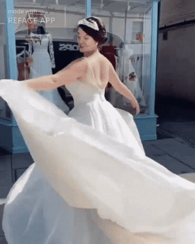 A Woman In A Wedding Dress Is Dancing In Front Of A Store With The Number 280 On It GIF