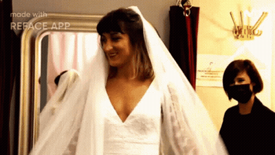 A Woman In A Wedding Dress With A Veil Is Made With The Reface App GIF