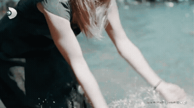 A Woman In A Wetsuit Is Reaching Into The Water With A Linkedin Logo In The Background GIF