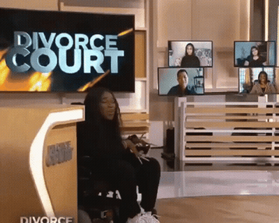 A Woman In A Wheelchair Is Sitting In Front Of A Tv That Says Divorce Court GIF