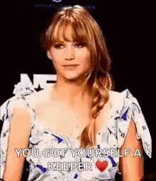 A Woman In A White And Blue Dress Is Holding A Heart And Says `` You Got Yourself A Keeper `` . GIF
